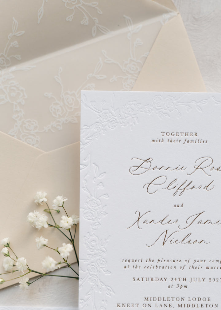 Wedding invitation card with floral design on beige envelope