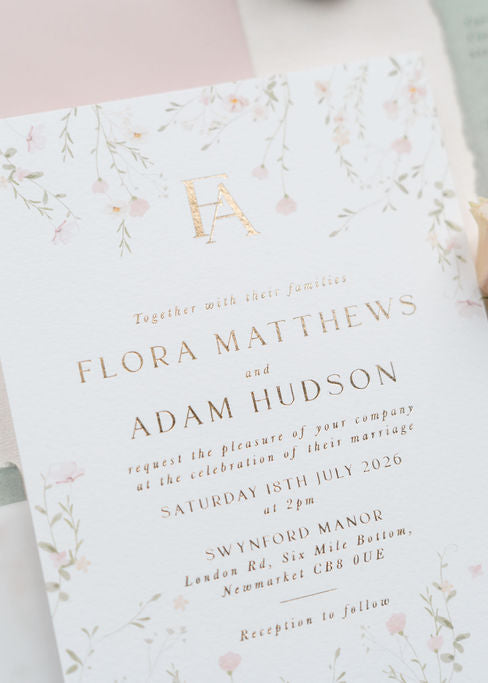 Wedding invitation card with floral design on a light background