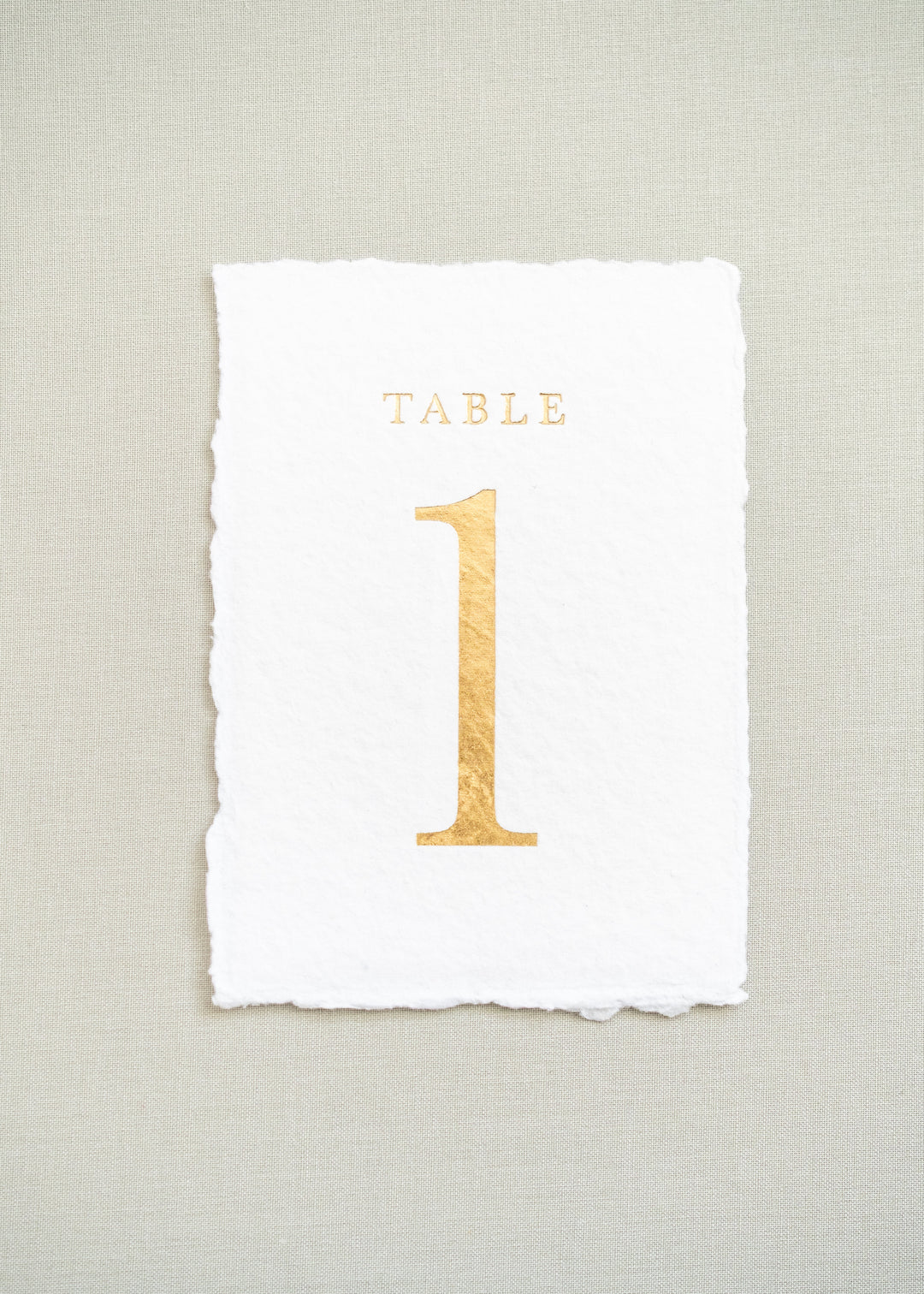 White handmade paper and gold foil table number 1