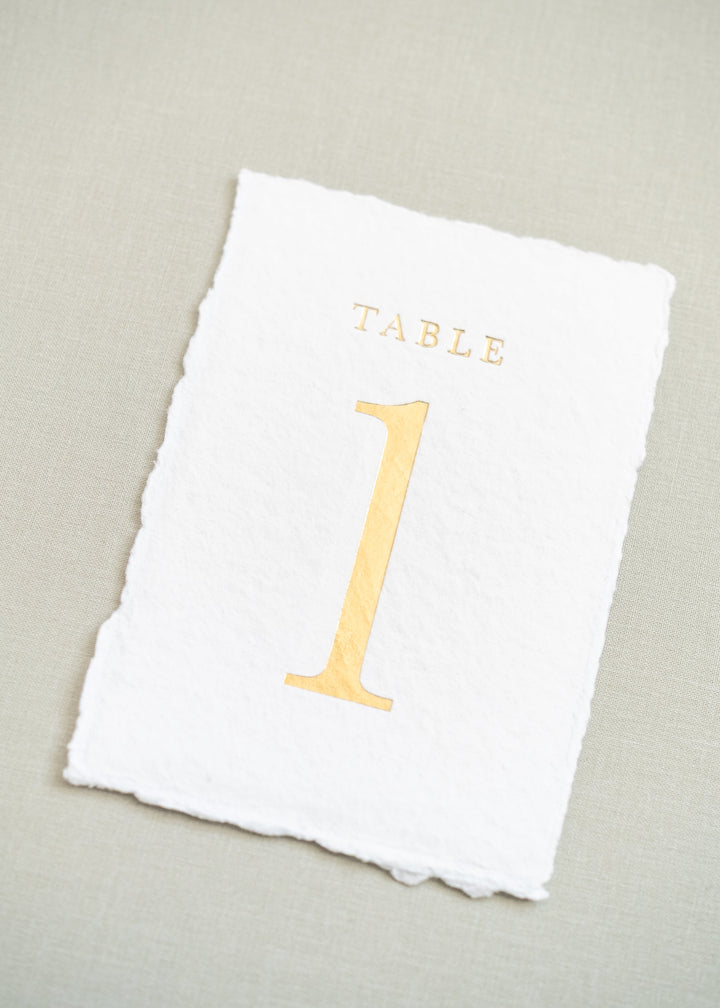white handmade paper and gold foil table number 1